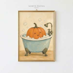 May include: A framed wall art print titled NORTH PATINA PRINTS featuring an orange pumpkin with a smiling face sitting in a light blue clawfoot bathtub filled with white bubbles and a vintage-style shower head fixture against a beige background.