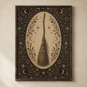 May include: A framed wall art print featuring a central broomstick illustration inside an oval frame. The background is a dark floral pattern with crescent moons and stars. The broom is tied with twine and adorned with small circular charms.