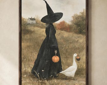 May include: A framed wall art print depicting a figure in a long black dress and a pointed witch hat walking through a field. The figure holds an orange pumpkin, while a white goose walks alongside carrying a small dark basket in its beak.