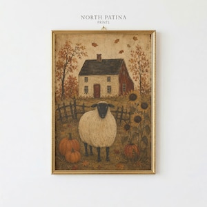May include: A framed art print titled NORTH PATINA PRINTS featuring a painting of a white sheep standing in a field with orange pumpkins, sunflowers, and a dark-roofed house in the background. The scene includes autumn leaves and a wooden fence.