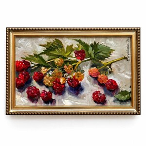 May include: An oil painting in a gold frame depicting a cluster of red and yellow raspberries with green leaves on a textured white background. The artwork features visible brushstrokes and is signed N. Hryshchenko '26y in the upper right corner.