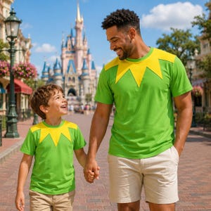 May include: Two matching short-sleeved t-shirts in bright green with a yellow collar detail featuring a pointed, star-like design. The shirts are paired with beige shorts, creating a coordinated look with a vibrant colour scheme and simple construction.