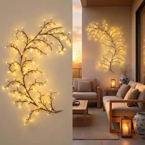 May include: Decorative branch with warm white LED lights. The branch is dark brown with a glittery texture, mounted on a light-colored wall. The lights are evenly spaced along the branches, creating a soft glow. Ideal for home decor.