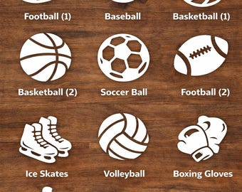 May include: A wooden surface displays white cut-out designs of various sports equipment and activities. The image includes a football, baseball, basketball, soccer ball, ice skates, volleyball, boxing gloves, a runner, a swimmer, and a bicycle. Text at the top reads "CHOOSE YOUR DESIGN."