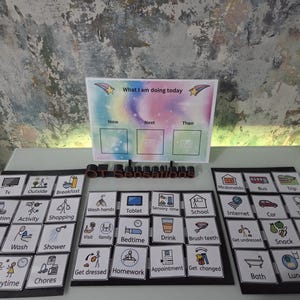 May include: A visual schedule system with a colourful "What I am doing today" board and multiple activity cards. The cards feature icons representing daily tasks like "Breakfast," "School," and "Playtime," designed for visual learners.