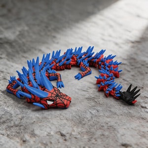 May include: A flexible, articulated dragon figurine featuring a red body with a black web pattern, accented by numerous bright blue spikes along its back and head. The creature has white eyes and a black tail tip, designed with multiple segments.