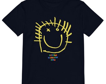 Camiseta infantil 100% algodón orgánico, con estampado de sonrisa dibujado a mano, ideal para combinar con otros conjuntos familiares.