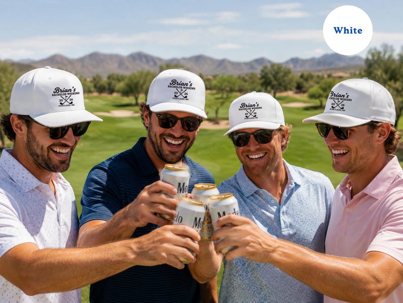 May include: A white baseball cap featuring a black embroidered graphic with the text "Brian's BACHELOR WEEKEND 20 26" and an illustration of two crossed golf clubs. The cap has a structured crown, a curved brim, and a button on the top.