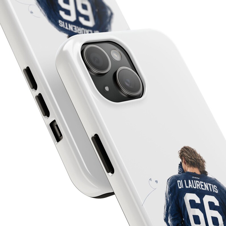 May include: White phone case featuring a close-up of a blue jersey with the name "DI LAURENTIS" and the number "66". The case also displays the word "LAURENTIS" and the number "99" in a circular design. The phone's camera and buttons are visible.