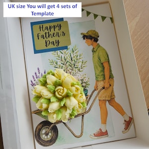 May include: A rectangular card featuring a watercolor illustration of a person pushing a wheelbarrow filled with plants. The text "Happy Father's Day" is printed in black script. A cluster of pale yellow buttercream flowers sits on the card.