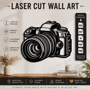 May include: A black and white laser cut wall art design of a DSLR camera. The graphic features the text LASER CUT WALL ART at the top and a sidebar listing file formats including SVG, DXF, AI, PDF, and PNG for digital download and laser cutting.