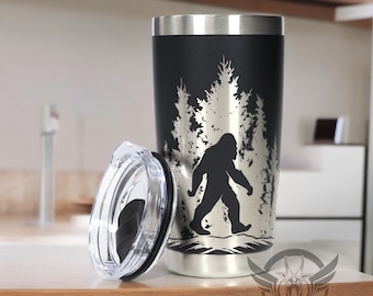 Laser engraved Sasquatch in the trees graphic on a 20oz stainless steel double walled tumbler