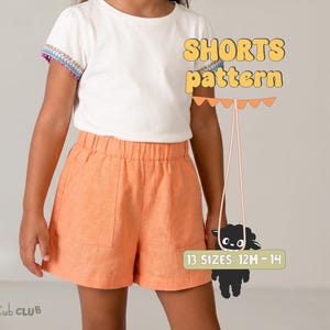 May include: A child wearing orange shorts and a white t-shirt. The t-shirt has colourful trim on the sleeves. The image includes the text "SHORTS pattern" and "13 SIZES: 12M-14".