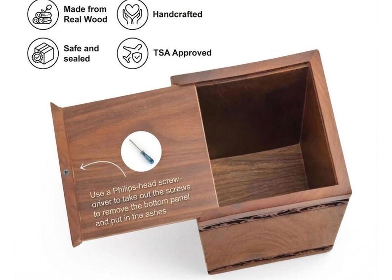 May include: A brown wooden cremation urn with a sliding bottom panel. The panel features text instructions to use a Phillips-head screwdriver to remove screws for access. Icons indicate the item is made from real wood, handcrafted, and TSA approved.