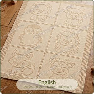 May include: A rectangular beige knit blanket featuring a grid of six squares, each displaying a different embossed animal design including a lion, a cow, a penguin, a hedgehog, a fox, and a deer, finished with a textured border around the edges.