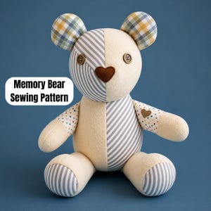 May include: A stuffed bear toy featuring a patchwork design of cream-coloured fabric, grey and white diagonal stripes, and multi-coloured polka dots. The bear has button eyes, a heart-shaped nose, and text that reads Memory Bear Sewing Pattern.