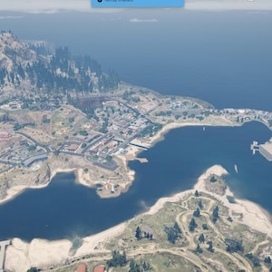 May include: A white ceramic mug with a black handle and the text "But First, Coffee" in a bold, black font. The mug is set against a blurred background, suggesting a cozy setting.