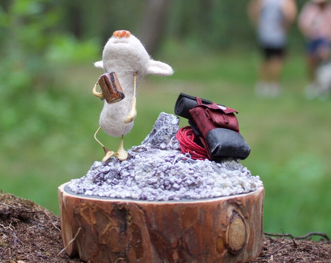 bear on a peak of a mountain with a backpack and hiking gear holding a coffee filled mug, felted creature miniature - tiny stump diorama