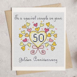 May include: A cross-stitch anniversary card with a heart-shaped design. The heart is yellow and contains the number 50, surrounded by yellow and pink hearts and leaves. The card reads "To a special couple on your Golden Anniversary."