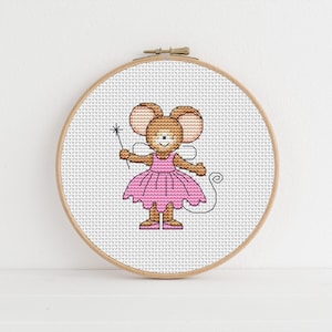 May include: A cross-stitch embroidery hoop with a design of a brown mouse wearing a pink tutu and holding a magic wand.