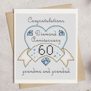May include: A cross-stitch greeting card with a diamond anniversary theme. The card features a blue heart with the words "Diamond Anniversary 60" and "Congratulations grandma and grandad". The card is on a white background with a brown envelope.