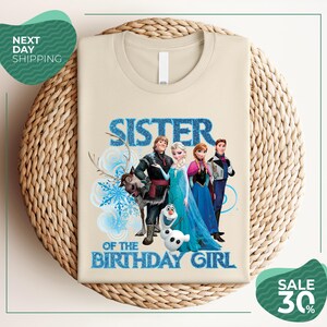 A t-shirt with a design featuring characters from the Disney movie Frozen, specifically the sisters Elsa and Anna, along with the text "SISTER OF THE BIRTHDAY GIRL".