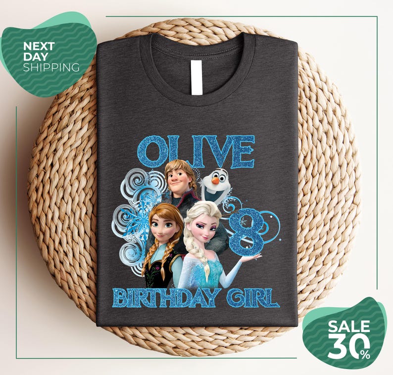 A gray t-shirt with a graphic design featuring characters from the Disney movie Frozen, specifically Olive, the birthday girl.