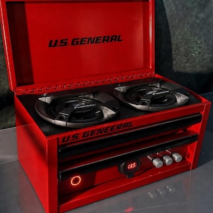 May include: A red U.S. GENERAL portable stereo system with two speakers and a digital display showing "13.5". The top of the unit opens to reveal the speakers. The text "U.S. GENERAL" is printed on the top and front.