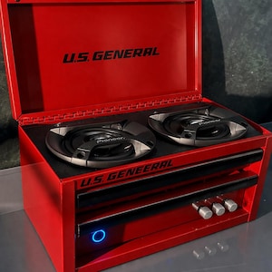 May include: A red U.S. GENERAL toolbox with the lid open, revealing two Pioneer speakers. The toolbox has black accents, a drawer, and control knobs. The text "U.S. GENERAL" is printed on the lid and front.