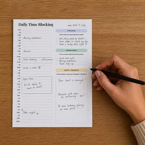 May include: A white daily time blocking planner sheet with black text and colored sections for top tasks, bonus tasks, and notes. The planner features an hourly schedule from 6 AM to 10 PM, with handwritten entries in black ink throughout the document.