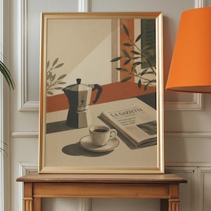 May include: A framed art print depicting a silver moka pot, a white coffee cup on a saucer, and an open newspaper titled LA GAZZETTA resting on a table. The scene features warm light, shadows, and green foliage, all enclosed in a gold frame.
