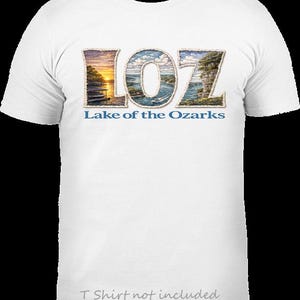 May include: A white t-shirt featuring the text LOZ in large letters, with each letter filled with a detailed landscape illustration of the Lake of the Ozarks. Below the letters, the text Lake of the Ozarks is printed in blue.