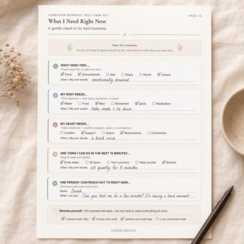 What I Need Right Now caregiver check-in worksheet filled with handwritten notes and checkmarks on a soft beige flat lay with dried flowers, a cup, and pen.