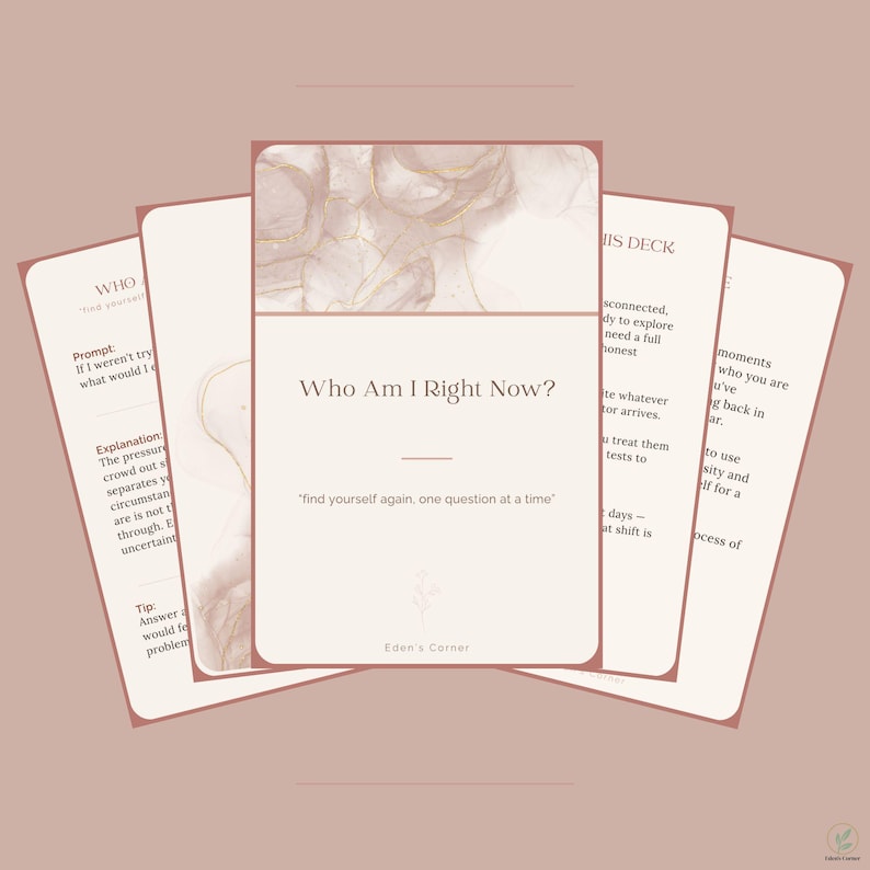 May include: A deck of cards with a soft beige and dusty rose color palette. The central card features the text Who Am I Right Now? and find yourself again, one question at a time. The top of the card displays an abstract marble pattern.