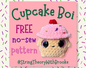 May include: A crochet plush toy shaped like a cupcake with a tan base, pink frosting, and a red cherry on top. The text reads Cupcake Boi, FREE no-sew pattern, @StringTheoryWithBrooke, and Save this post for later! on a pink background.