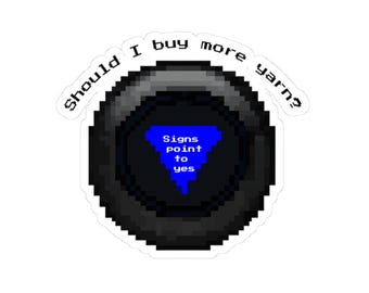 May include: A sticker featuring a black Magic 8-Ball with the text "Should I buy more yarn?" and "Signs point to yes." The 8-ball has a blue triangle with white text. The design is pixelated.