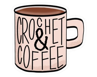 May include: A sticker featuring a coffee mug with the words "CROCHET & COFFEE" in black lettering. The mug is light pink with a brown coffee fill and a matching handle. The sticker has a white border.
