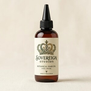 May include: A brown glass bottle of Sovereign Studios Botanical Hair Oil, 4 fl oz (118 ml). The bottle has a black cap and a label with a crown design and the words "Sovereign Studios" and "Botanical Hair Oil". The label also states the product is cruelty-free and vegan.