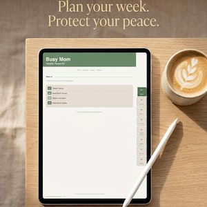 May include: A digital tablet displaying a "Busy Mom Weekly Reset Kit" with a green and beige interface, a white stylus, and a latte with leaf art on a wooden table. Text at the top reads "Plan your week. Protect your peace."