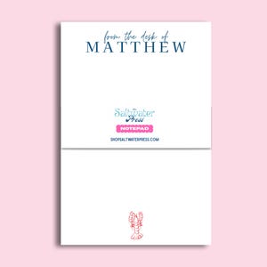May include: White notepad with the text "from the desk of MATTHEW" in navy blue. The notepad features the "Saltwater Press" logo and a pink "NOTEPAD" label. A red lobster illustration is at the bottom.