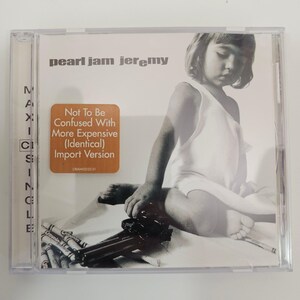 May include: A Pearl Jam Jeremy maxi single CD in a clear plastic case. The cover features a black and white photograph of a child with a toy gun and crayons. A brown sticker reads: Not To Be Confused With More Expensive (Identical) Import Version.