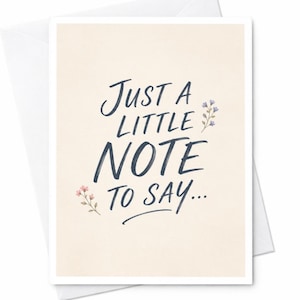 May include: A cream-coloured greeting card featuring the dark blue handwritten text "JUST A LITTLE NOTE TO SAY..." centred on the front. Small, delicate illustrations of pink flowers on the left and blue flowers on the right decorate the text.