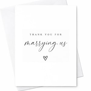 May include: A white card with a matching envelope. The card features the text "THANK YOU FOR marrying us" in a mix of sans-serif and elegant script fonts, with a small heart symbol below the text. The card is a wedding thank you card.