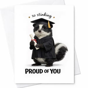 May include: A graduation greeting card featuring a skunk wearing a graduation cap and gown, holding a diploma. The card reads "so stinking proud of you" in black text. The skunk is black and white with a fluffy tail.