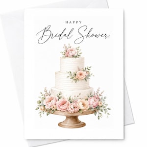 May include: A white greeting card featuring a three-tiered cake on a wooden pedestal. The cake is decorated with pink roses and green foliage. The text "HAPPY Bridal Shower" is printed in black ink at the top center of the card design.