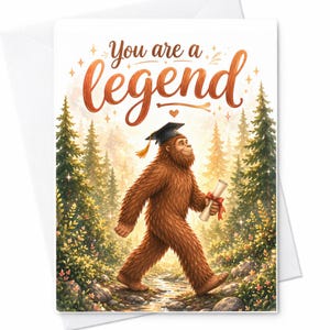 May include: A greeting card with the words "You are a legend" in orange script. The card features an illustration of a Bigfoot wearing a graduation cap and holding a diploma, walking through a forest.