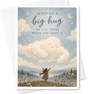 May include: A greeting card featuring a person standing on a hill with arms outstretched toward a large, smiling cloud in a blue sky. The text reads: SENDING A big hug SO IT'S THERE WHEN YOU NEED IT. The scene includes a landscape with trees and a house.