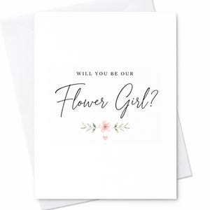 Op de afbeelding: Een witte wenskaart met de zwart gedrukte tekst WILL YOU BE OUR Flower Girl? gecentreerd op de voorzijde. Onder de tekst staat een kleine aquarelillustratie van een enkele roze bloem met groene bladeren en een klein roze hartje eronder.
