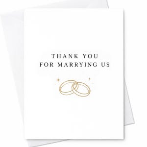 May include: A white greeting card featuring the black text THANK YOU FOR MARRYING US centered at the top. Below the text are two interlocking gold-colored rings illustrated with thin lines, accompanied by two small four-pointed star accents.