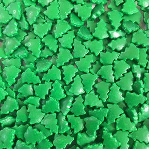 May include: A close-up image of a large quantity of green sugar sprinkles shaped like Christmas trees.